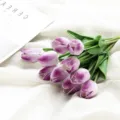 Detailed closeup of purple artificial PU tulips bouquet on textured white fabric background. - Mini Tulip - White Purple