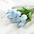 Detailed view of artificial blue gradient tulip bouquet with green leaves on white cloth. - Mini Tulip - White Blue