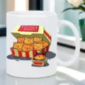Vista dettagliata della tazza da caffè in ceramica bianca con stampa di gattini nuggets. - Stile Gattini Nuggets