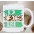 White ceramic coffee mug with green and leopard print St. Patrick's Day text detail. - Irish Lucky Style