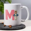 Custom ceramic coffee mug with pink letter M and cute religious cartoon illustration print for office. - 10