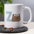 White ceramic coffee mug featuring custom letter Z and mountain landscape print for office. - 14