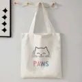 Casual witte canvas shopper tas met een schattig katten gezicht en kleurrijke opdruk. - Katten Illustratie Stijl