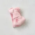 Close-up detail of soft pink knit baby headband with cute bow pattern, premium texture. - One Size / Pink Bow Headband