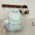 Mochila escolar verde menta con detalles rosados, lindo colgante de peluche de estrella y bolsillos. - Verde + Estrella Enojada