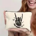 Canvas zipper makeup bag featuring a skeleton hand spooky rock design, perfect for Halloween styling. - 1