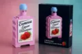 Building block strawberry cream liquor bottle detail view with box and pink background. - Strawberry Cream Liquor Bottle