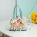 Clear jelly tote bag with inner straw bag, daisy print, ribbon bow, and chain strap. - Blue