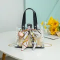 Clear PVC tote bag with daisy print, straw inner pouch and stylish silk scarf bow. - Black