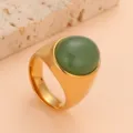 Detailed close-up of gold stainless steel ring with smooth green dome stone, fashion accessory. - Size 6 / Gold Base Green