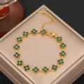 Close-up of green zircon four leaf clover bracelet detail, luxury gold steel jewelry accessory. - Gold Green Zirconia