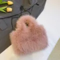 Pink fluffy faux fur shoulder bag featuring a dark chain strap, stylish winter crossbody handbag. - Pink