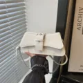 Vintage white underarm shoulder bag for women, chic retro motorcycle style with buckle. - White