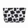 Stijlvolle zwart-witte gewatteerde cosmetische tas, veelzijdige puffer clutch tas voor dames. - Koeienprint