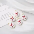 Detailed shot of oval enamel red bow charms, perfect for DIY jewelry and handmade necklace making. - Red Bow / 1 Piece (20mm*14mm)