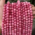 Close-up detail of pink natural stone round bead strands for DIY jewelry and bracelet making. - Rhodochrosite Style (BF510) / 4MM Round Beads (Approx 92 Pcs)