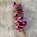Closeup detail view of 9-head artificial phalaenopsis orchid branch with purple spotted petals - Color 1