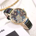 Detailed view of bohemian style women quartz watch with ethnic canvas strap and gold case. - Style M