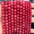 Gros plan détaillé de brins de perles rondes en pierres roses, idéal pour la création de bijoux DIY. - Rhodochrosite d'Argentine Optimisée
