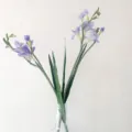 Artificial purple freesia flower bouquet in glass vase for home decor wedding table setup. - Purple