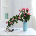 Artificial flower vine detail view, decorative pink floral hanging plant for home room wall decor. - Pink