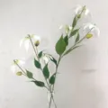 Artificial Gloriosa lily flower detail shot, elegant floral arrangement in a glass vase. - White