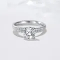 Exquisite 1 carat moissanite ring detail showcasing brilliant solitaire and paved sterling band. - Size 5 / Silver