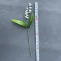 Detail view of artificial lily of the valley flower branch, soft rubber plastic plant for decor. - 2 Branches