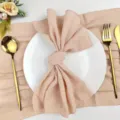 Detailed view of textured wrinkled table napkin and elegant gold cutlery set for dining table decor. - 42*42 / Apricot