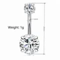 Stainless steel belly button ring with sparkling zirconia stones, navel piercing jewelry detail. - Round