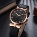 Elegante reloj de cuarzo para mujer con lazo elegante, correa negra y esfera texturizada. - Negro