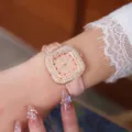 Detail shot of women's pink rhinestone square quartz watch with starry crystal dial and leather strap. - Rose Gold Case Pink