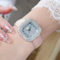 Detailed close-up of women's square quartz watch with diamond bezel and pink leather strap. - Silver Case Pink Dial