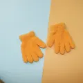 Close-up shot of soft orange fuzzy winter gloves, perfect for kids' outdoor wear and daily warmth. - Orange