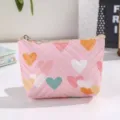 Cute pink leather coin purse detail featuring colorful heart quilted patterns and zipper closure. - Pink