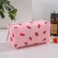 Strawberry corduroy makeup bag detail, showing cute print and soft fabric texture nicely. - Pink