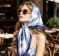 Close-up detail of the elegant blue and white silk scarf styled gracefully as a head wrap. - 90x90cm / Blue and White Porcelain
