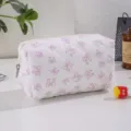 Pink quilted bow cosmetic bag, portable large capacity storage pouch for daily travel. - Purple