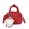 Red polka dot bowling bag detail showcasing cute fluffy doll keychain and textured fabric. - With Pendant / Red