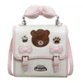 Leuke roze en witte schoudertas met strikhandvat en schattige berenborduurwerk design. - Roze