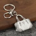 Exquisite rhinestone handbag keychain, metal alloy material with white dripping oil, great decor. - White K + White
