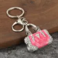 Metal rhinestone handbag keychain detail, stylish pink enamel bag charm keyring for backpacks. - White K + Pink