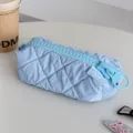 Light blue quilted cosmetic bag with oversized zipper, stylish travel makeup storage pouch. - Blue