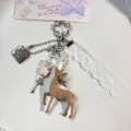 Cute deer keychain detail, pink and white aesthetic with delicate lace ribbon and charms. - Pink Deer