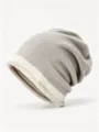 Closeup view of the winter colorblock knit beanie, cozy slouchy warm cap in gray and beige. - One Size / Khaki Beige