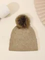 Detail view of a cozy knit beanie with sparkly sequins and fluffy pom-pom for winter warmth. - One Size / Khaki