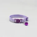 Pet collar detail view featuring purple plaid woven fabric, safety buckle and cat bell. - Purple