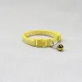 Yellow plaid pet collar detail featuring woven fabric, secure plastic buckle and metal bell. - Yellow
