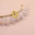 Close-up of lace pet collar detail featuring a cute handmade yellow crochet flower and pink ribbon. - S / Off White