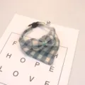 Close-up detail of the cute blue plaid pet collar with bow and bell for cats and dogs. - Navy Blue